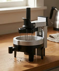 Heavy Hitter Rotary Espresso Puck Distributor Tool Featuring Adjustable Height And 12 Precision Points To Crush Clumps Level Coffee Grounds Evenly Compact Barista Accessory For Home Daily Driver Setup on wooden countertop.