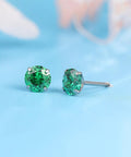 Close-up of Snag Dope G23 Implant Grade Titanium Screw Back Earrings with green cubic zirconia for sensitive skin.