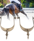 Two Pack Vintage Carved Zinc Alloy Horse Spurs For Roping And Equestrian Competition in front of a horse rider.