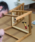Man assembling furniture with Adjustable M10 Furniture Leveling Feet Set With ABS And Iron Inserts 30 Pack Heavy Duty Table Leg Levelers.