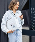 Person holding 12x15.5 white poly mailer, bulk pack 500, self adhesive shipping envelopes for clothes, waterproof mail bags