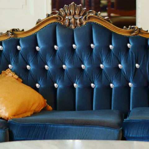 Top Notch Crystal Upholstery Tacks Set Of 60 Dope Diamond Furniture Buttons on a blue tufted sofa with gold pillow.