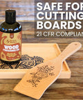 Straight Up Coconut Mct Wood Finishing Oil And Food Safe Cutting Board Sealer on wooden background with spatula and tray.