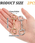 Hand holding two piece horse bit buckle set silk scarf buckle ring D ring snaffle bit buckles for women DIY snaffle horse jewelry.