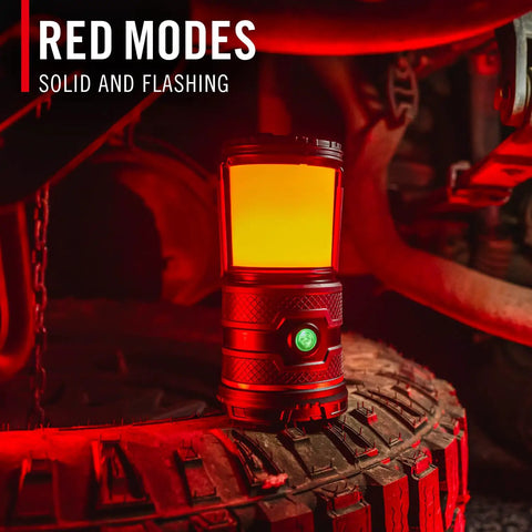 1000 Lumen USB C Rechargeable Emergency Camping Lantern in red mode on a tire showcasing solid and flashing red light feature