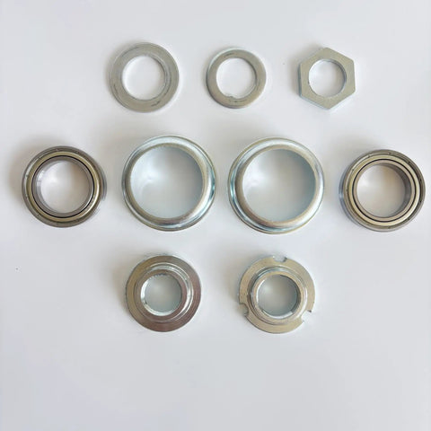 Nine piece silver 2 Inch Cup Bottom Bracket Set For One Piece Crank Bikes With 6906Z Sealed Bearings visible on white background
