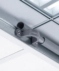 Killer Grip 20 Pack PVC Pipe Clamps Half Inch Conduit Straps securing a half inch pipe on a metal track for cable routing.