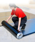 Woman applying Heavy Duty Waterproof Roof Repair Tape Self Adhesive Bitumen With Aluminum Foil on a surface.