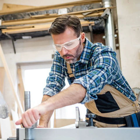 Man wearing 10 Pack Clear Safety Glasses With ANSI Z87.1 Scratch Resistant Polycarbonate Lenses, Wraparound Eye Protection in workshop