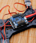 RC flight controller mounted on drone frame with wiring, showing anti vibration rubber balls set for F4 and F7 M3x8mm mounting.