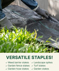 Close-up of hands installing landscape fabric using Flip Washer Garden Stakes And Landscape Staples, 6 Inch Metal Yard Spikes.