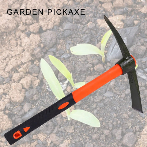 Heavy Duty Mattock With Fiberglass Handle For Digging, Breaking Hard Soil, Landscaping, Camping, weeding on soil background.