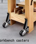 Retractable Workbench Casters With Quick Release Plate Four Pack Polyurethane Stepdown Wheels mounted on wooden workbench.