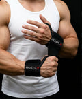 Man wearing black weightlifting wrist wraps for heavier lifts 18 inch and 12 inch premium wrist support straps.