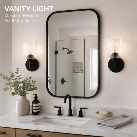 AOIOUR 10.4" 1‑Light Farmhouse Vanity Wall Sconce, Ribbed Glass Matte Black next to a mirror and sink in a bathroom.