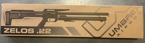 Box of Zelos 22 Caliber PCP Pellet Gun Air Rifle With 20 Round Rotary Magazine shown in black print on brown packaging