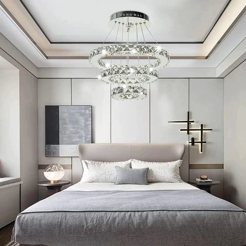 Slick Modern Crystal LED Chandelier with Adjustable Stainless Steel Rings Three Ring Pendant Lights in bedroom setting