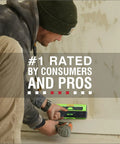 Person using 13 Sensor ProSensor M210 Stud Finder for wood and metal studs against a wall with a power tool nearby.