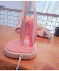 Back view of the Pink Dancing Shoes Table Lamp For Girls Room with pink base on wooden desk, E26 LED bulb, push button switch visible.