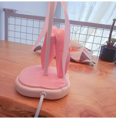 Back view of the Pink Dancing Shoes Table Lamp For Girls Room with pink base on wooden desk, E26 LED bulb, push button switch visible.