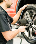 Mechanic using a Bolt Extractor Set for Stripped Nuts, 3/8 Inch Square Drive, Heavy Duty 41Cr4 Steel on car wheel