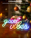 Good Vibes Neon Sign For Wall Decor With Addressable Dream Color LEDs in multicolor mood on wooden table near Christmas tree