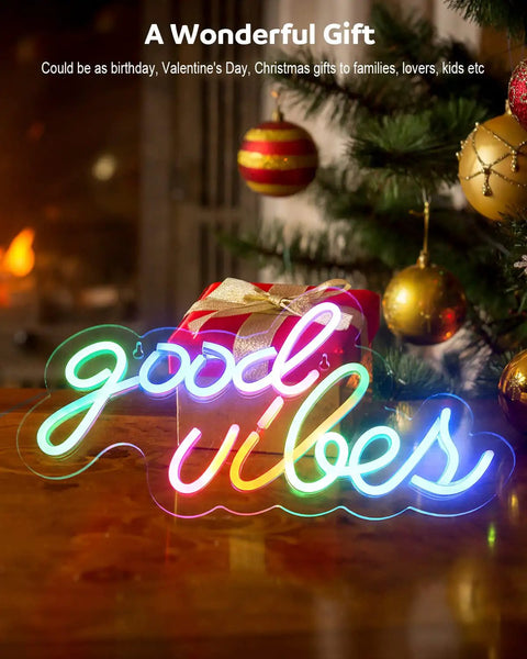 Good Vibes Neon Sign For Wall Decor With Addressable Dream Color LEDs in multicolor mood on wooden table near Christmas tree