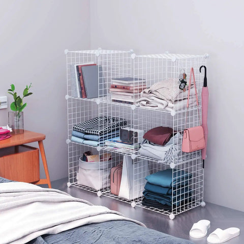 Eight Cube Wire Storage Organizer Kit with Metal Grid Shelving in bedroom, holding books, clothing, bins, and accessories.