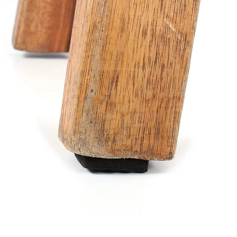 Close-up of chair leg with 48 Pack Black Rubber Feet Pads Non Slip Floor Protectors for furniture and appliances.