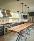 Industrial Mini Pendant Light Set With Bubble Seeded Glass Hanging Light Fixture For Kitchen Island Over Sink And Dining Room, Black Finish, 3-Pack Bundle illuminating a modern kitchen island.