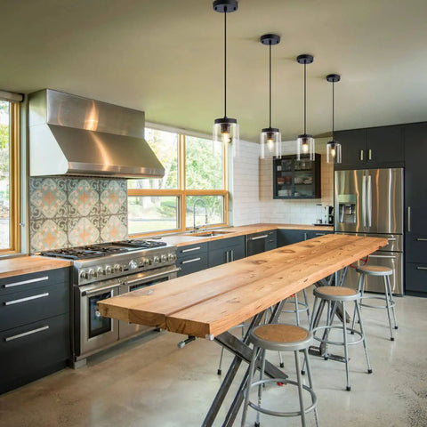 Industrial Mini Pendant Light Set With Bubble Seeded Glass Hanging Light Fixture For Kitchen Island Over Sink And Dining Room, Black Finish, 3-Pack Bundle illuminating a modern kitchen island.