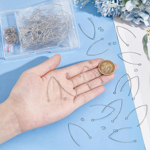 Hand holding About 100 Pcs 316 Stainless Steel Earring Hooks 2mm V Shape Ear Wires With 200 Pcs Open Jump Rings Kit.
