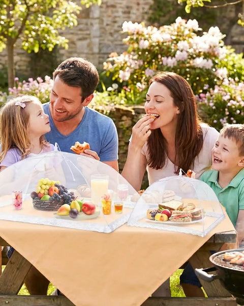 Family enjoying picnic with Outdoor Food Cover Set With Two Extra Large 40 By 25 Inch And Six Large 17 By 17 Inch Pop Up Mesh