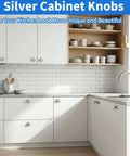Ten Pack Silver Round Cabinet Knobs One And A Quarter Inch Solid Aluminum Drawer Knobs shown on modern white kitchen cabinets.