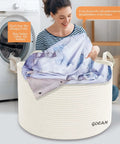 Woman using XXXL Cotton Rope Storage Basket With Handles Extra Large 22x22x14 Inches Woven Laundry Organizer Cream Color