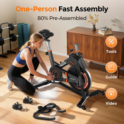 Woman assembling Magnetic Indoor Exercise Bike With Exclusive App in home studio setting