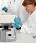 Lab technician using 4 Inch Lab Vibrator Shaker Oscillator 110V For Plaster And Gypsum Mixing Small Round Mixer Machine