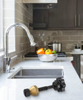 The Badass Faucet Reseating Tool With Precision Guide And Twin Steel Cutters To Nix Stubborn Leaks and Chip Off Mineral Crust Fast on a kitchen counter.