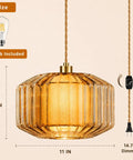 Plug In Dimmable Pendant Light Featuring Amber Drum Glass And Gold Fabric Inner Shade, 11in wide, 8in tall, with 14.7ft dimmable cord.