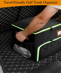 Person adjusting Double Layer Golf Trunk Organizer with Shoe Compartment and Waterproof Storage in car trunk, black and green.