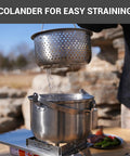Camping Cookware Set In 304 Stainless Steel With Pots Pan Kettle Colander And Tote For Campin Crew straining over pot