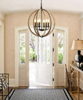Six Light Orb Farmhouse Chandelier In Brown Wood Globe Handcrafted Solid Wood Light Fixture For Your Dining Room, Living Room, Bedroom, Kitchen Island And Foyer, 20 Inch Diameter Cozy Rustic Vibe hanging in a foyer.