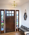 Black And Gold Dope Industrial 8 Light Geometric Pendant Chandelier in an entryway with wooden door and patterned bench.