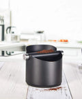 Espresso Knock Box For Home Barista Use Black Stainless Steel Coffee Ground Catcher With Removable Knock Bar on kitchen counter