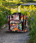 Underseat Carry On Rolling Bag For Women, 15 Inch Lightweight Weekender Luggage on path, floral pattern, telescoping handle extended.