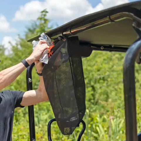 Heavy Duty UTV Trash Sack Durable PVC Mesh Garbage Bag for Trailside Cleanup attached to UTV, collecting debris with ease.