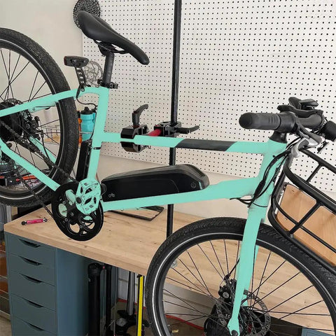 Portable Bike Repair Stand For On The Go Maintenance, Compact Space Saving Clamp Stand holding mint green bike in workshop