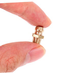 Close-up of copper nozzle from 25 Piece Grease Zerk Fitting Assortment Kit With Straight And Angled Copper Threaded Nozzles For Quick Lubrication Of Machinery And Equipment One Quarter By Twenty Eight Thread Size held between fingers.