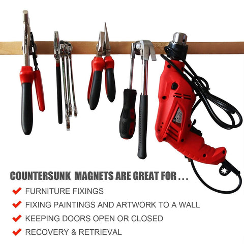 Front view of assorted hand tools hanging on a wooden rail, including pliers, screwdrivers, and a red power drill.