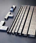 Beefy Heavy Duty Stainless Outdoor Trench Drainage Kit With Slim Low Profile Grate For Courtyard Lawn And Driveway Rust Resistant 304 Stainless Steel Splicable Design For Quick Easy Custom Drain Lines shown disassembled with L connectors